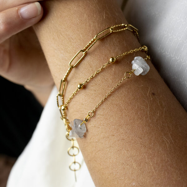 Bracelet en chaines mailles trombones et forçats en acier inoxydable avec fermoir bouée et perles de labradorite que l'on voit porté sur un poignet en gros plan